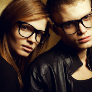 Portrait of gorgeous red-haired fashion twins in black clothes w